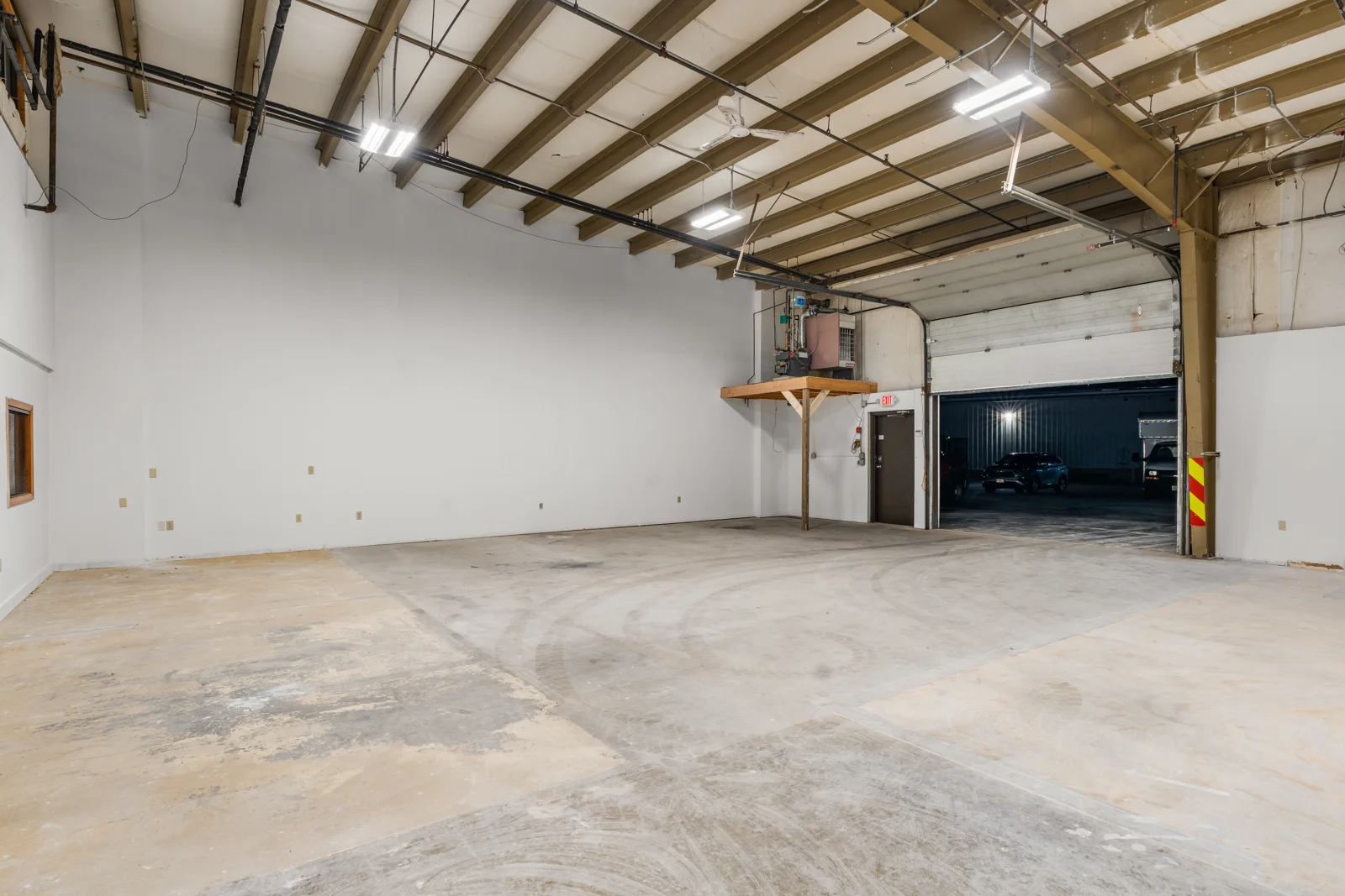 Warehouse interior looking toward an open overhead loading door